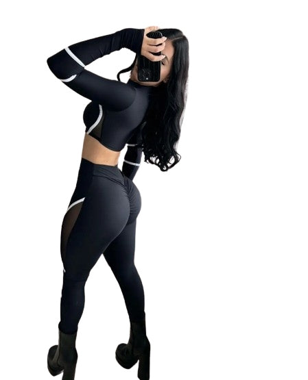 Two-piece sports set for women, long-sleeve, stretchy, with cutouts.